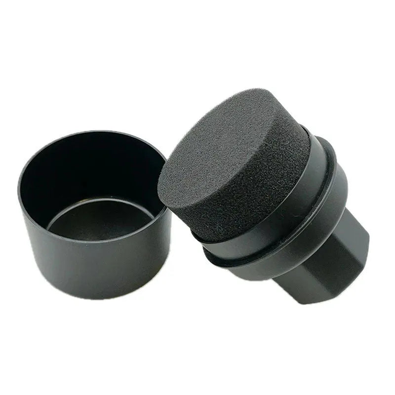 Black and red car tyre polishing sponge brushes with lids on a tyre, showing flat and curved sponge edges.