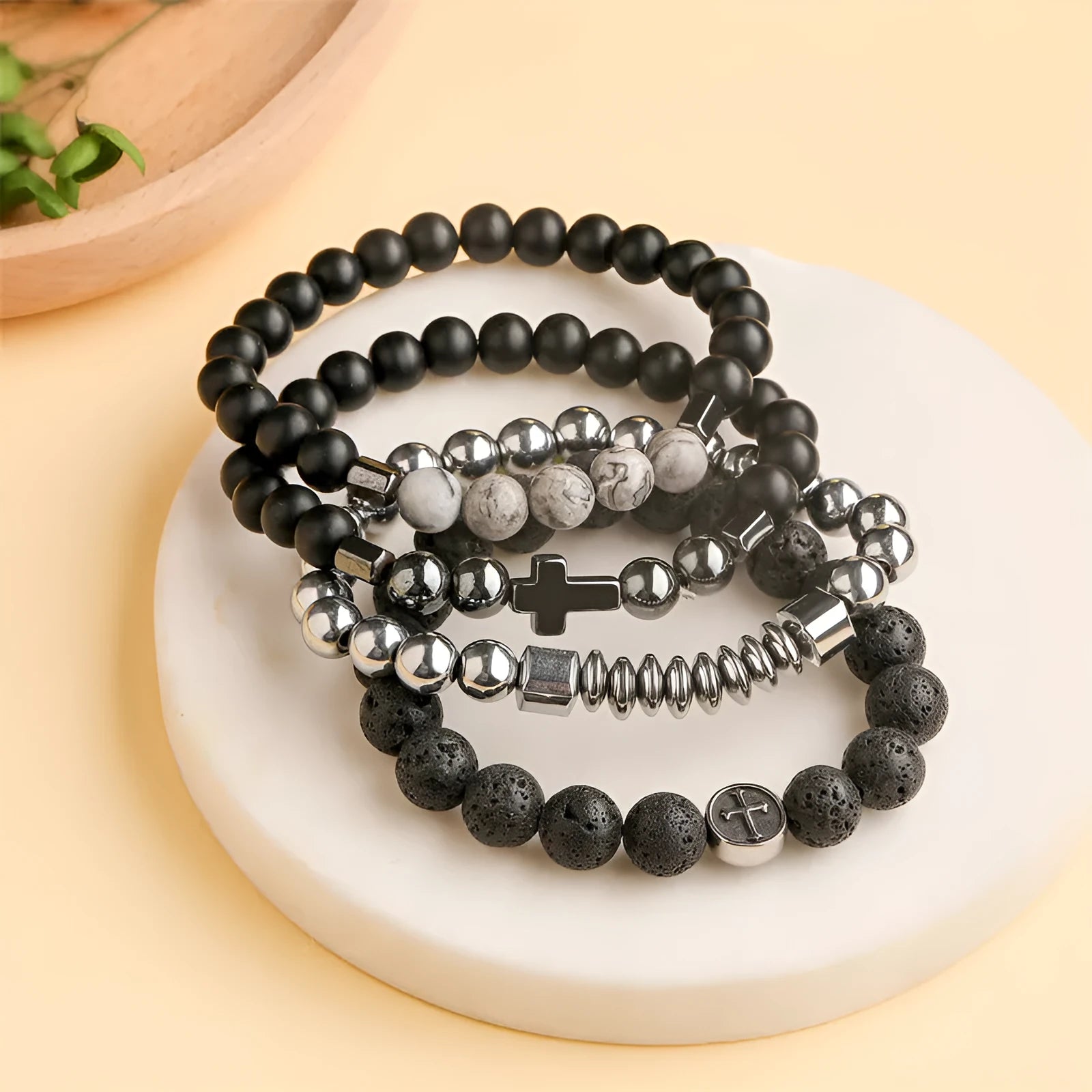 Geometric agate bracelet with volcano-coloured beads and stainless steel elements on a wrist.