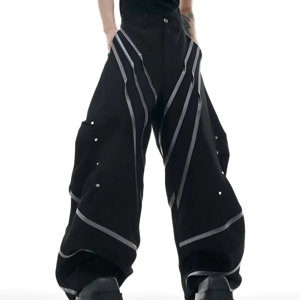 Men's black trousers with deconstructed three-dimensional cutting and metal rivets on the pleats