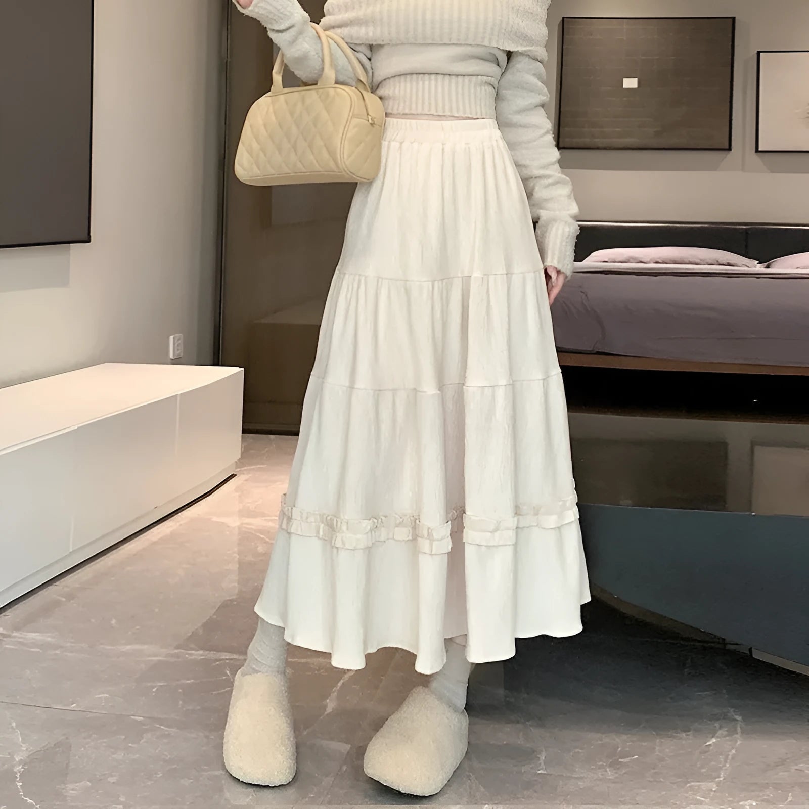 Corduroy A-line midi skirt with elastic waistband in milky white, shown on a hanger.