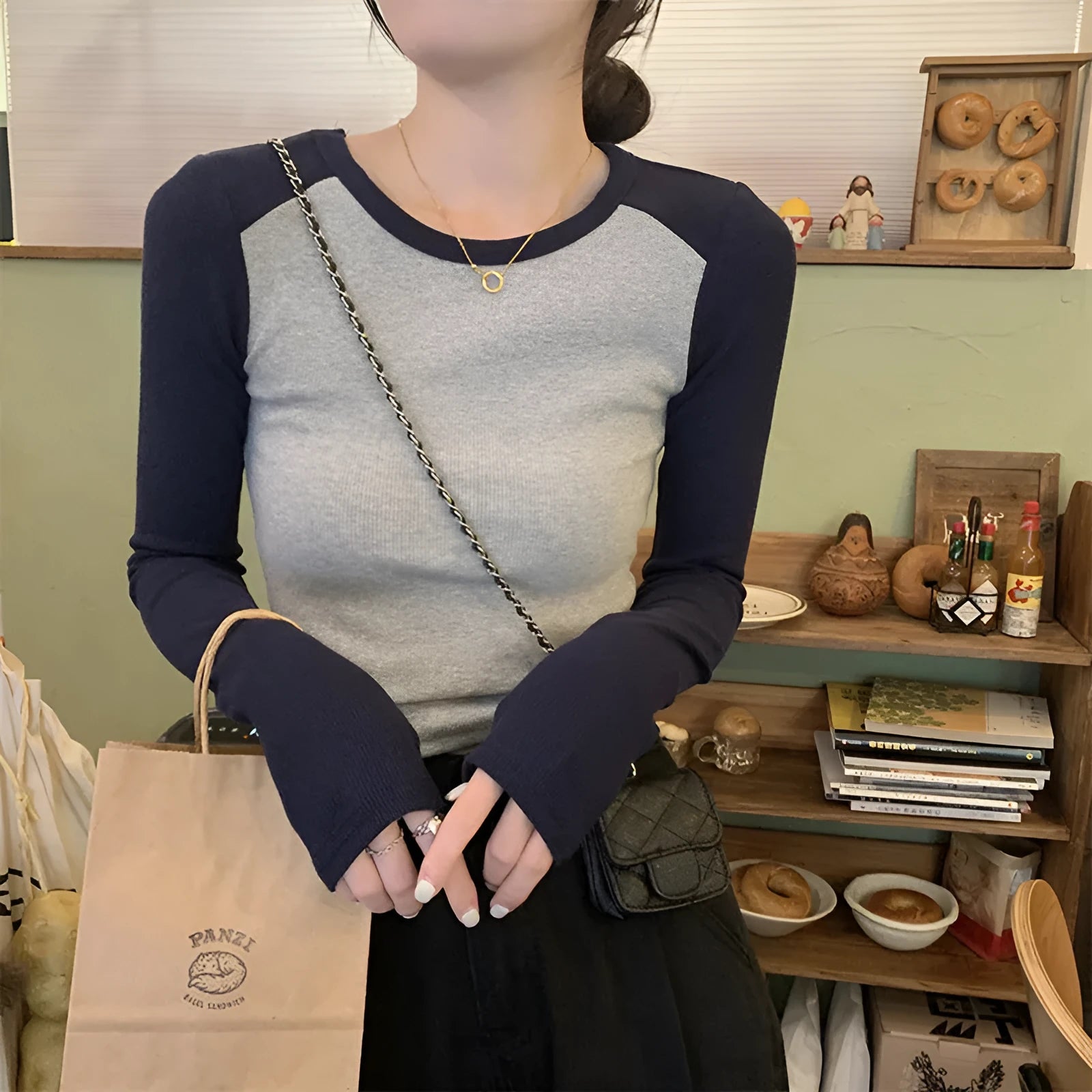 Women's oversized slim fit top with embroidery on the sleeves, shown in dark blue.