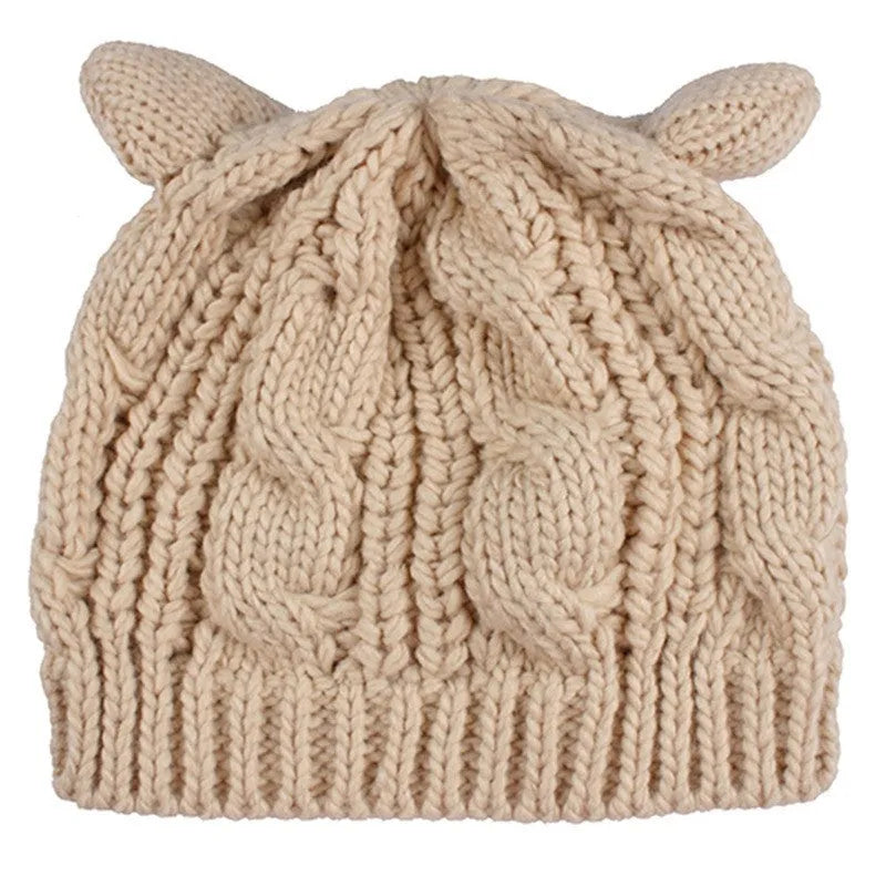 Hand-made red knitted beanie with 3D cat ears on a mannequin head