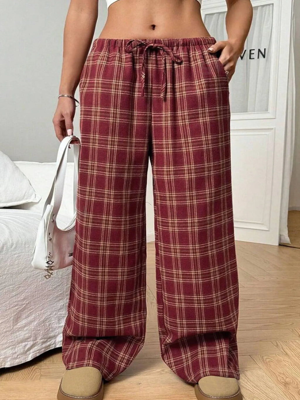 Women's loose fit plaid trousers with a drawstring waist and side pockets, shown in blue.