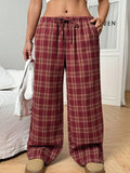 Women's loose fit plaid trousers with a drawstring waist and side pockets, shown in blue.