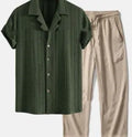 Man wearing a loose short sleeve shirt and matching trousers from the milk silk summer suit set.