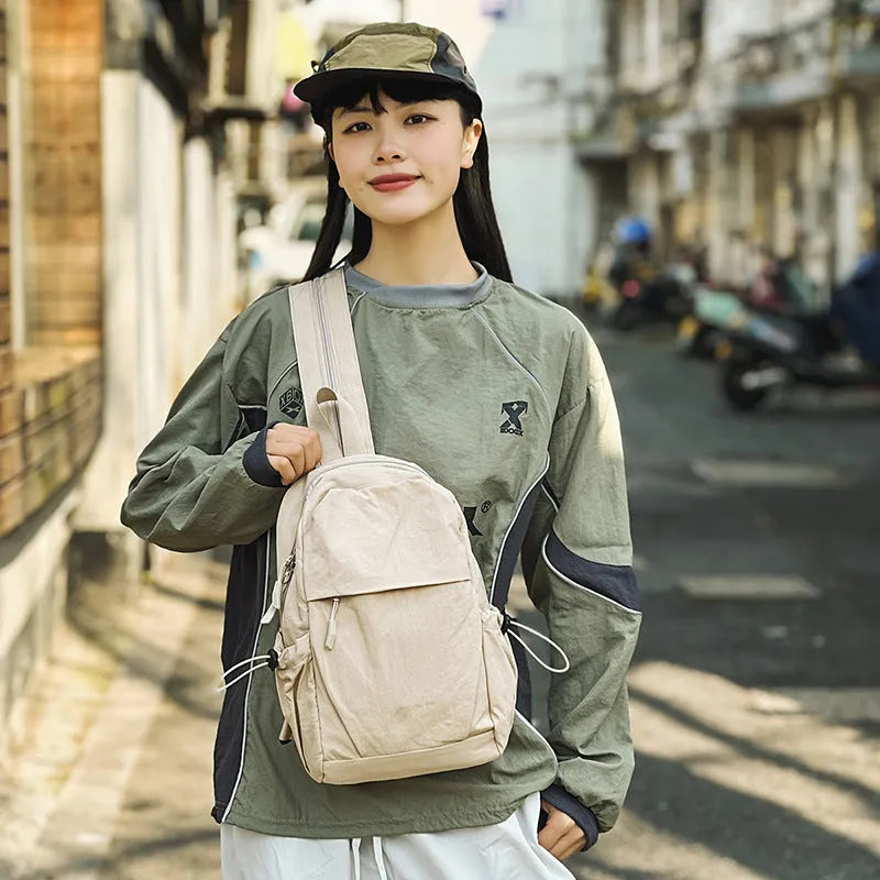 Multi-functional waterproof nylon backpack in black, free size, with curved shoulder strap and visible sewing thread detailing
