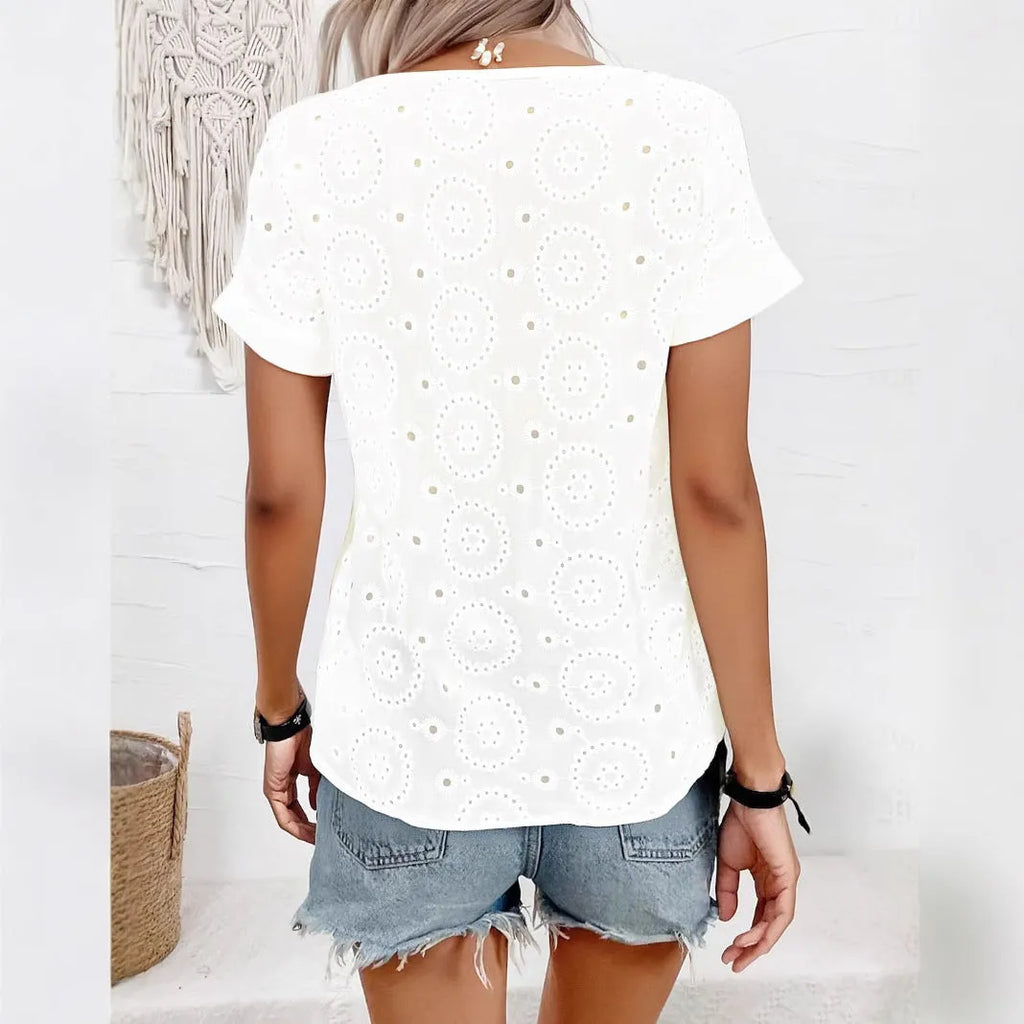 White women's V-neck T-shirt with hollow-out fabric detail and short sleeves on a hanger