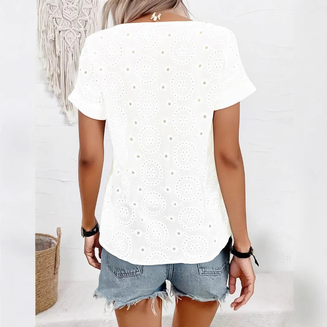 White women's V-neck T-shirt with hollow-out fabric detail and short sleeves on a hanger