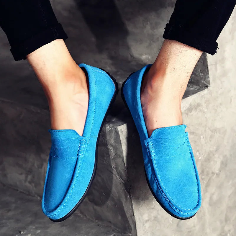 Men's brown suede Gommino casual loafers with a round toe and flat rubber sole.