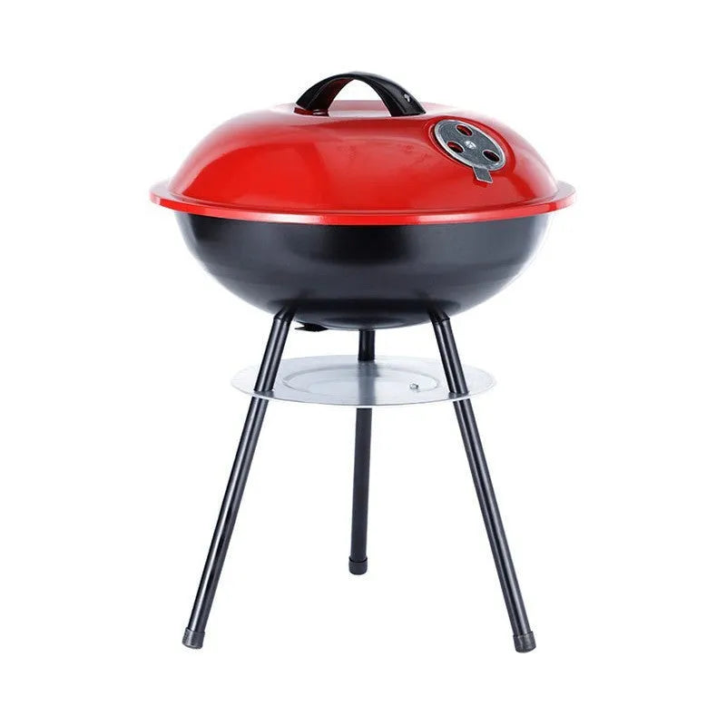 Portable round iron barbecue grill with 14-inch cooking grate, shown on a patio.