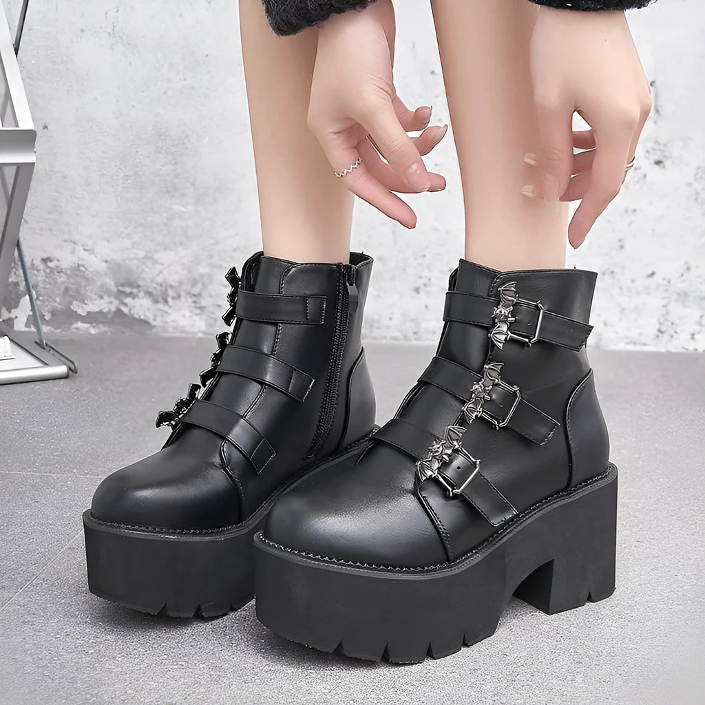 Black women's punk gothic ankle boots with a bat buckle and side zipper on a thick sole.