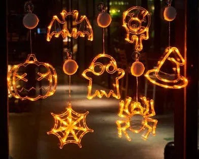 Seven Halloween themed battery-operated LED hanging lights with spider, pumpkin and ghost designs