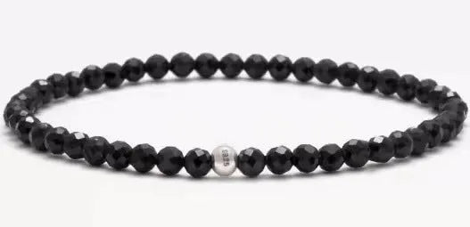 A unisex geometric bracelet with round and square obsidian, blue San and agate beads on a black background.