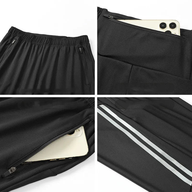 Black men's running trousers with a mid waist, laid flat to show the trousers length and sporty design.