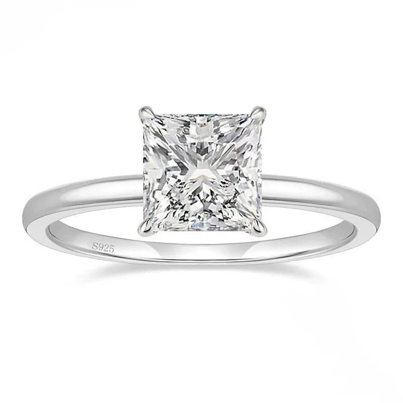 A simple geometric sterling silver ring with a round zirconia stone, shown in silver, gold, and rose gold finishes.