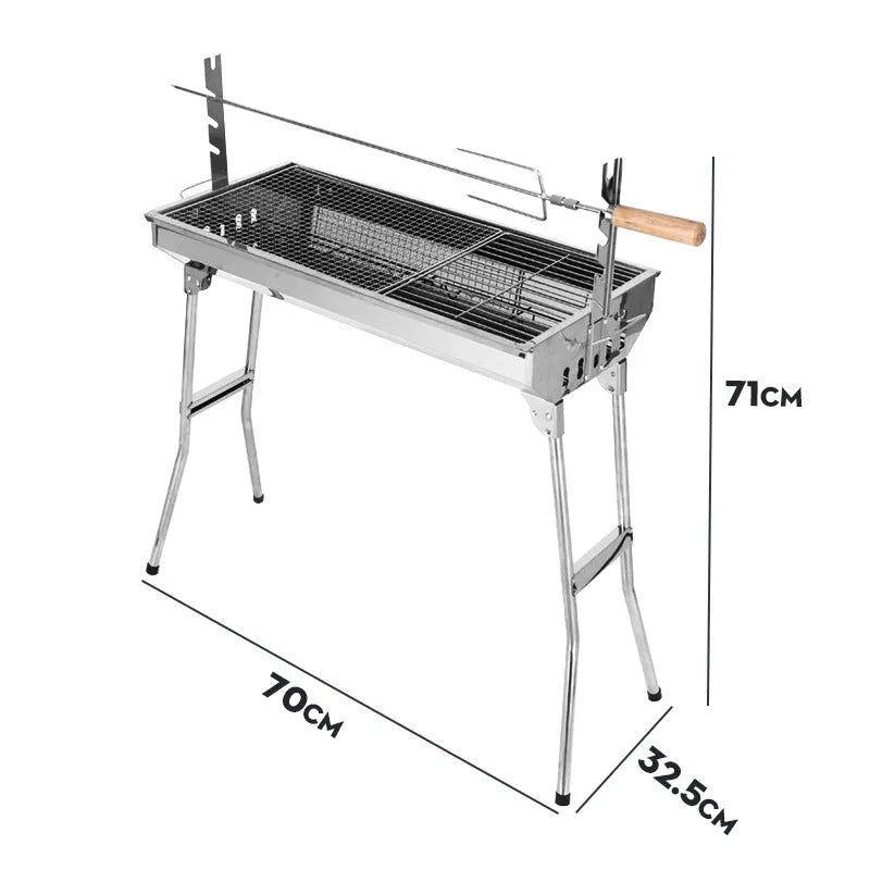 Large stainless steel portable charcoal barbecue oven with iron grill and cooking accessories.