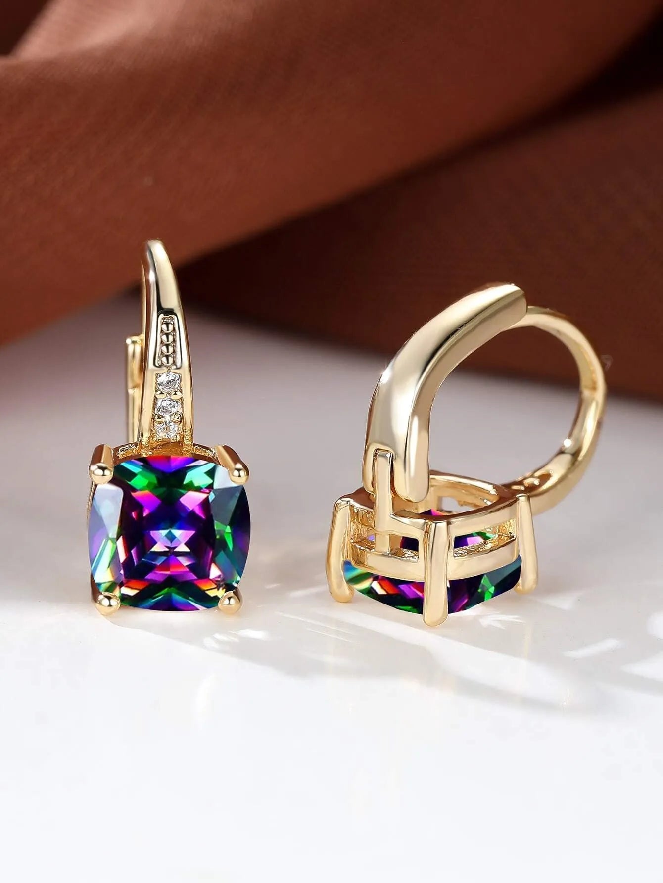Square geometric gold ear clip with colourful moissanite stone inlay.