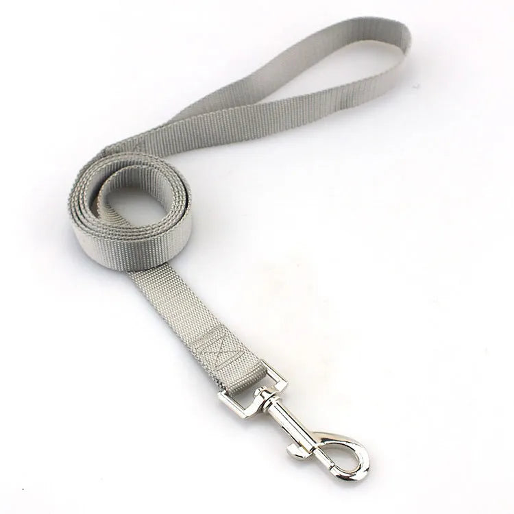 Solid colour nylon dog hand holding rope tug toy showing multiple colour options and size variations