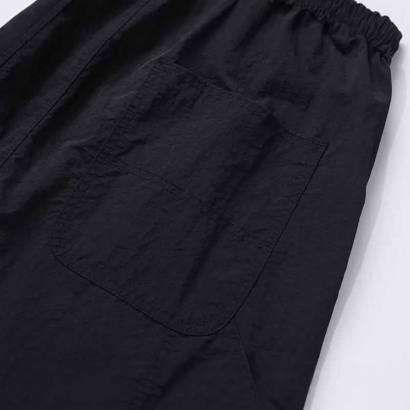 Black paratrooper pants with elastic waist and baggy style European American high street cut