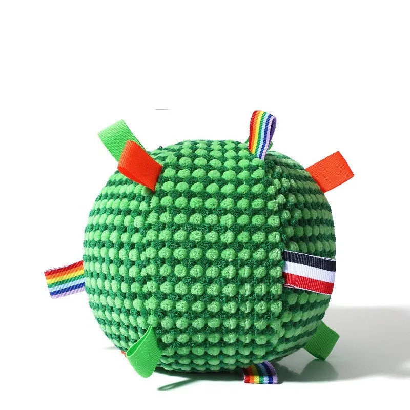Blue hollow plastic dog ball with pineapple lattice pattern and rattle inside on grass