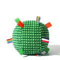 Blue hollow plastic dog ball with pineapple lattice pattern and rattle inside on grass