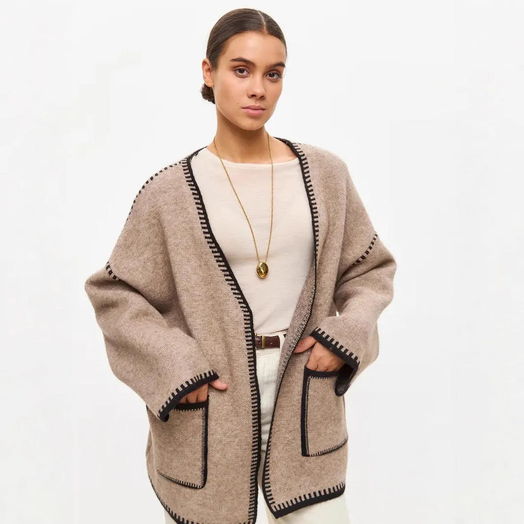 Loose black lace-up knitted cardigan on a hanger