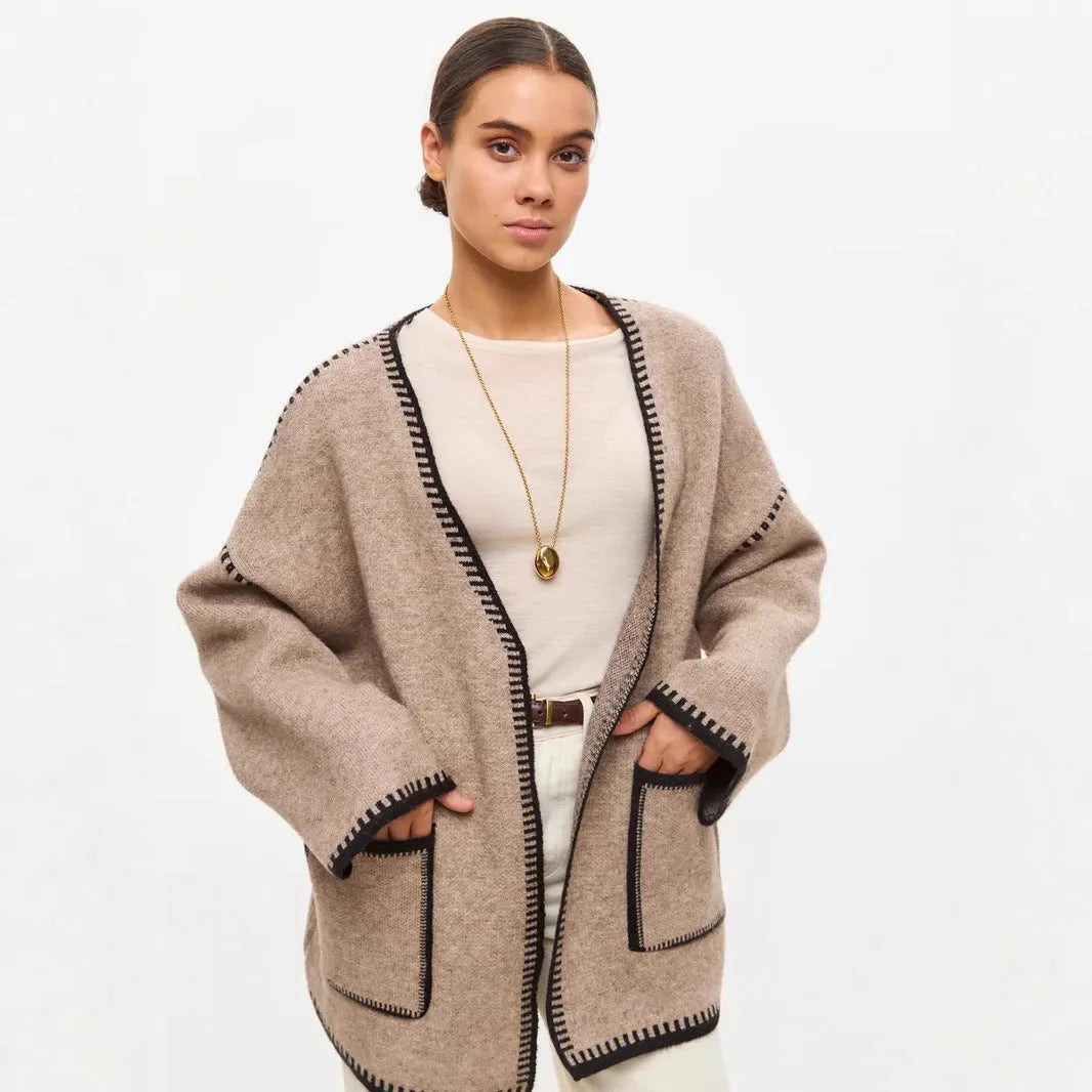 Loose black lace-up knitted cardigan on a hanger