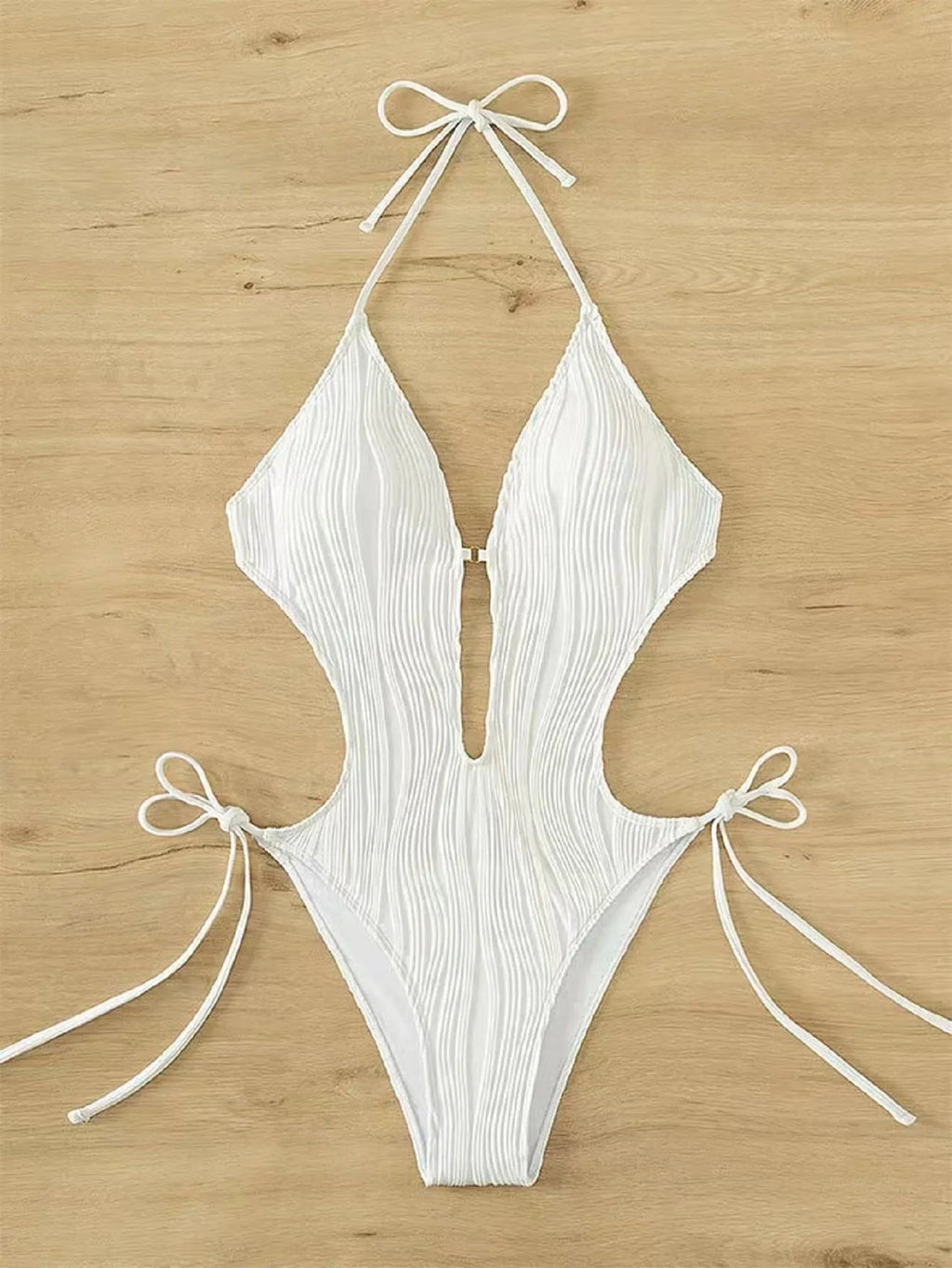 Women's black lace-up triangle bikini swimsuit with adjustable front detailing on mannequin