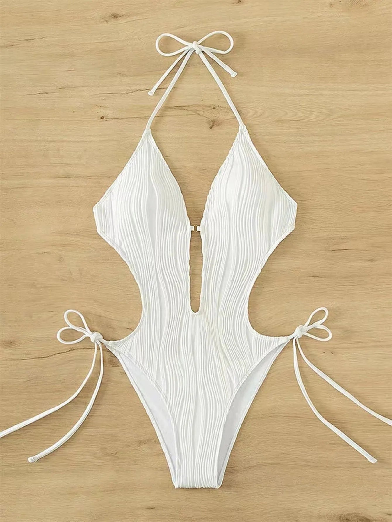 Women's black lace-up triangle bikini swimsuit with adjustable front detailing on mannequin