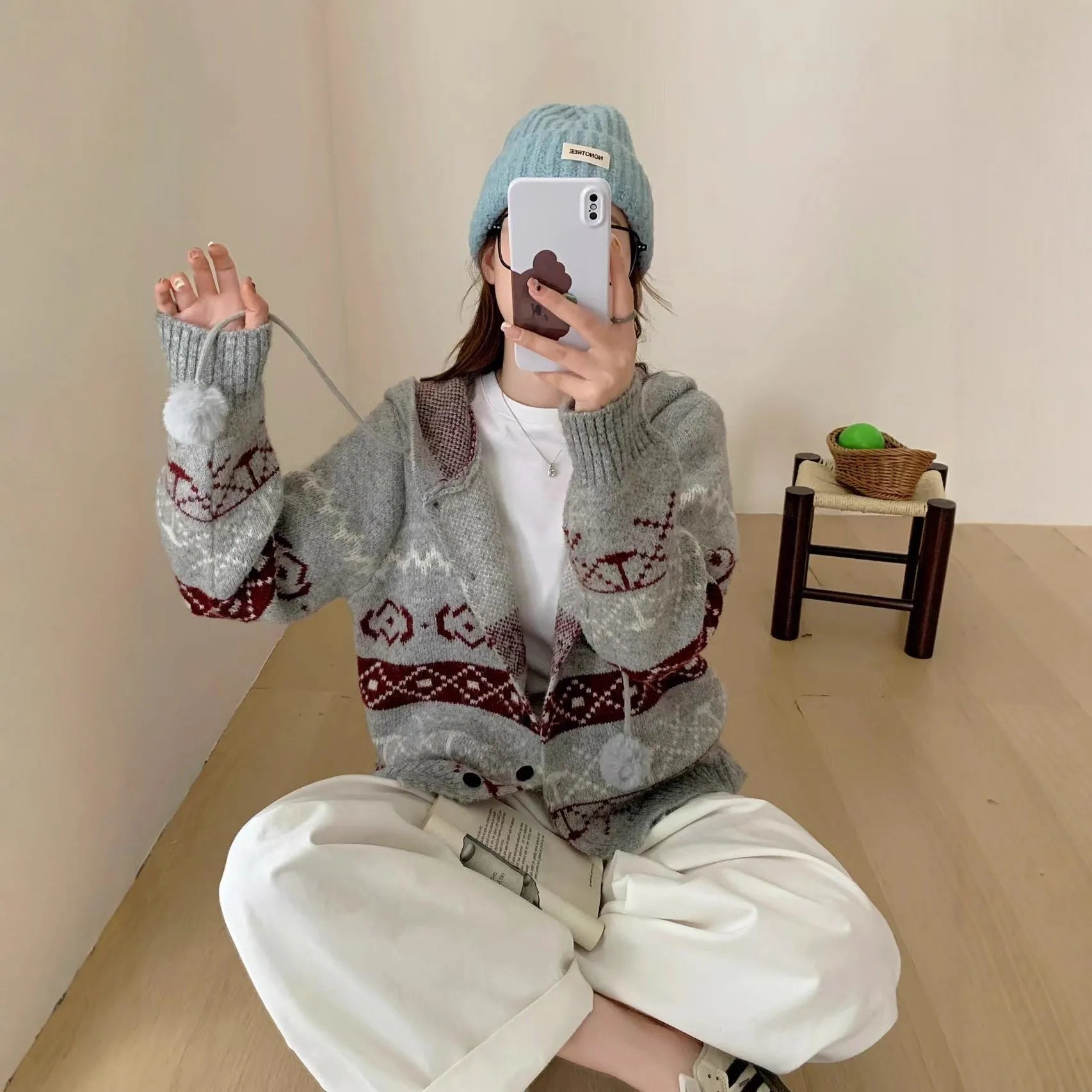 Plus size women's grey geometric pattern brocade knit sweater coat with long sleeves.