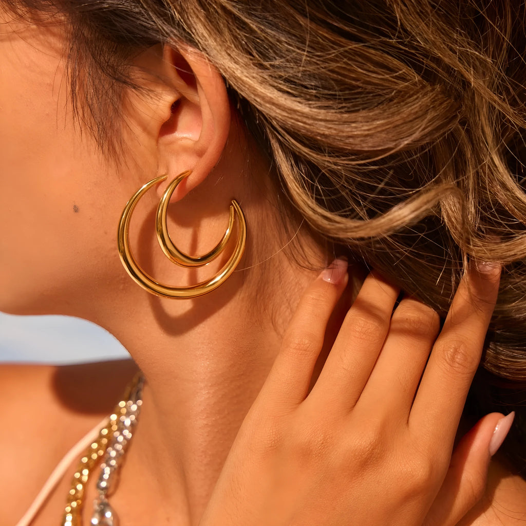 Simple titanium steel hoop earrings in gold and steel finishes, available in large and small circular sizes