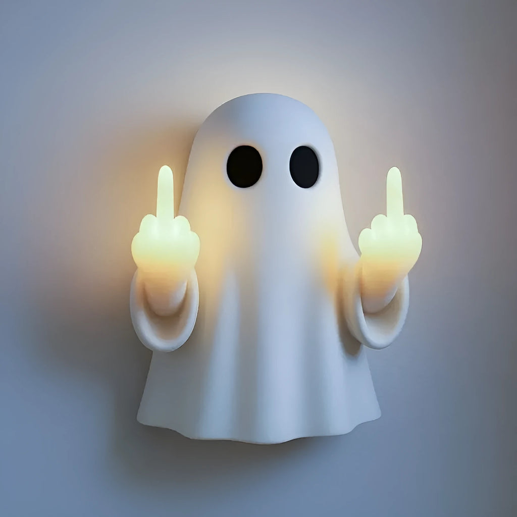 White cute ghost statue plastic night lamp for Halloween decoration on a dark surface.
