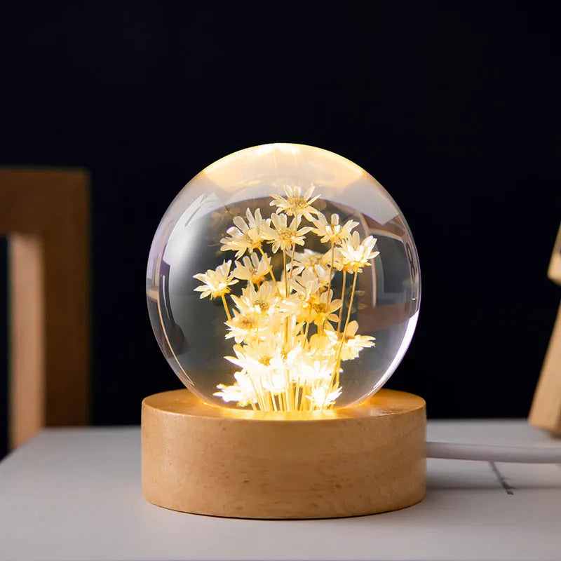 USB-powered eternal flower night light with clear resin crystal ball on a natural beech wood base.