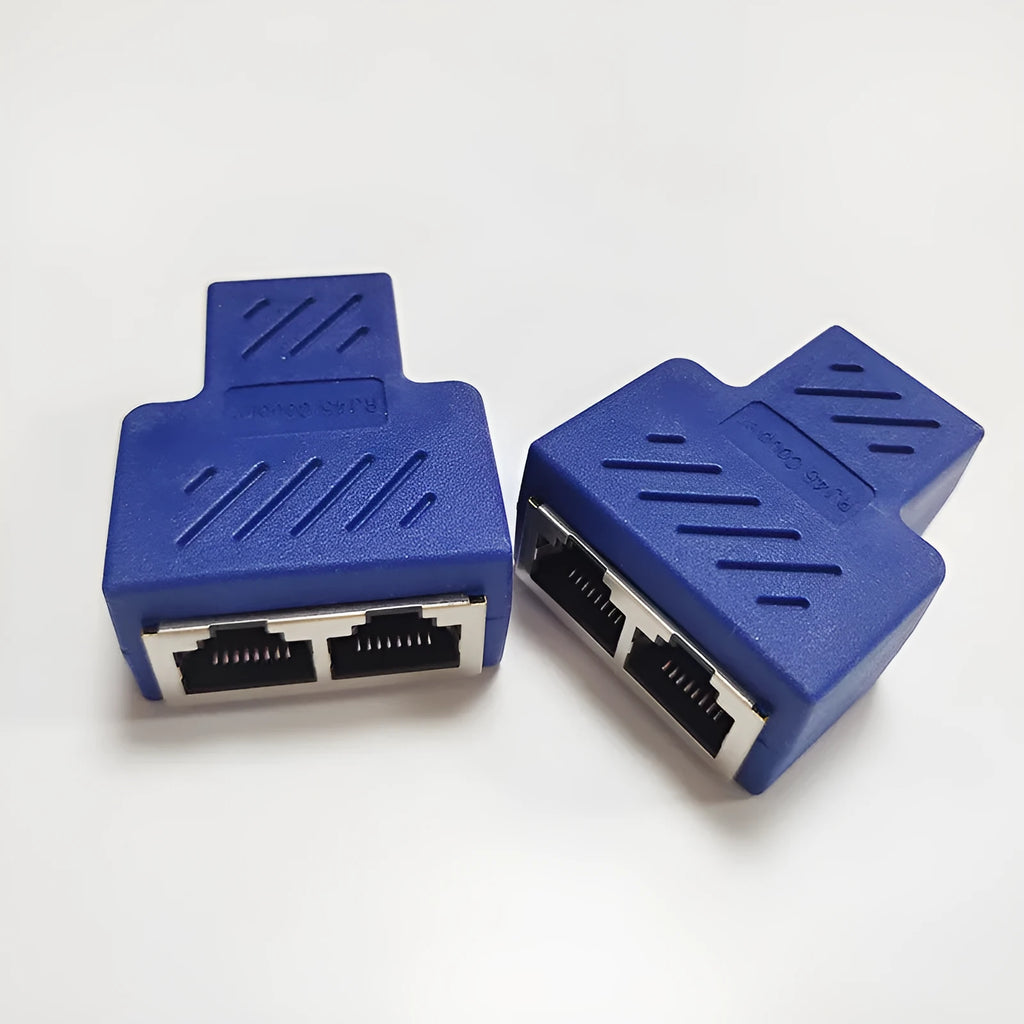 Two white RJ45 three-way tee network cable splitters on a surface