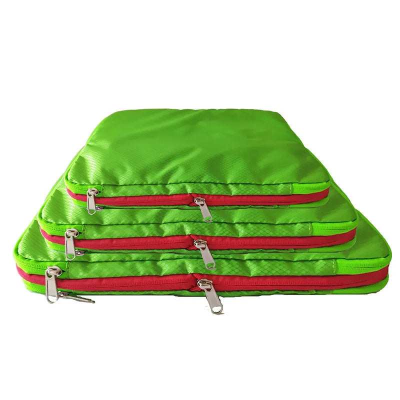 Green travel compression storage bag made of waterproof nylon in cube shape on a white background