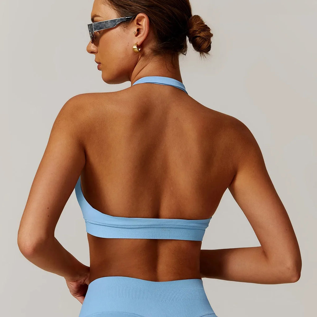 Women's black halter neck sports bra with removable padding for yoga and low-impact workout.