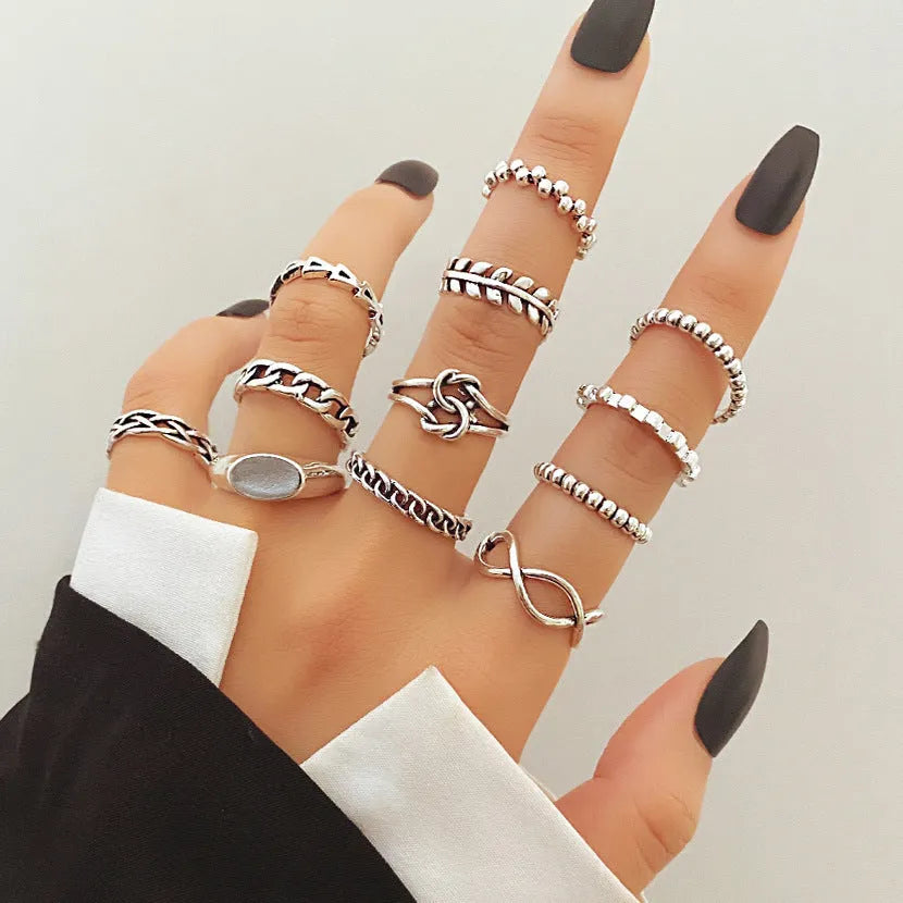 Alloy ring set with butterfly and snake retro geometric designs on display
