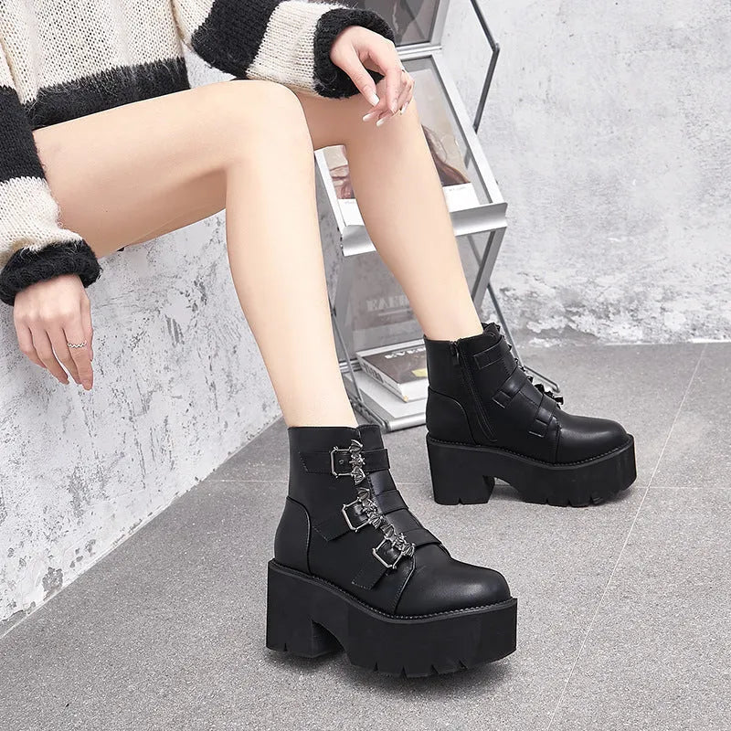 Black women's punk gothic ankle boots with a bat buckle and side zipper on a thick sole.