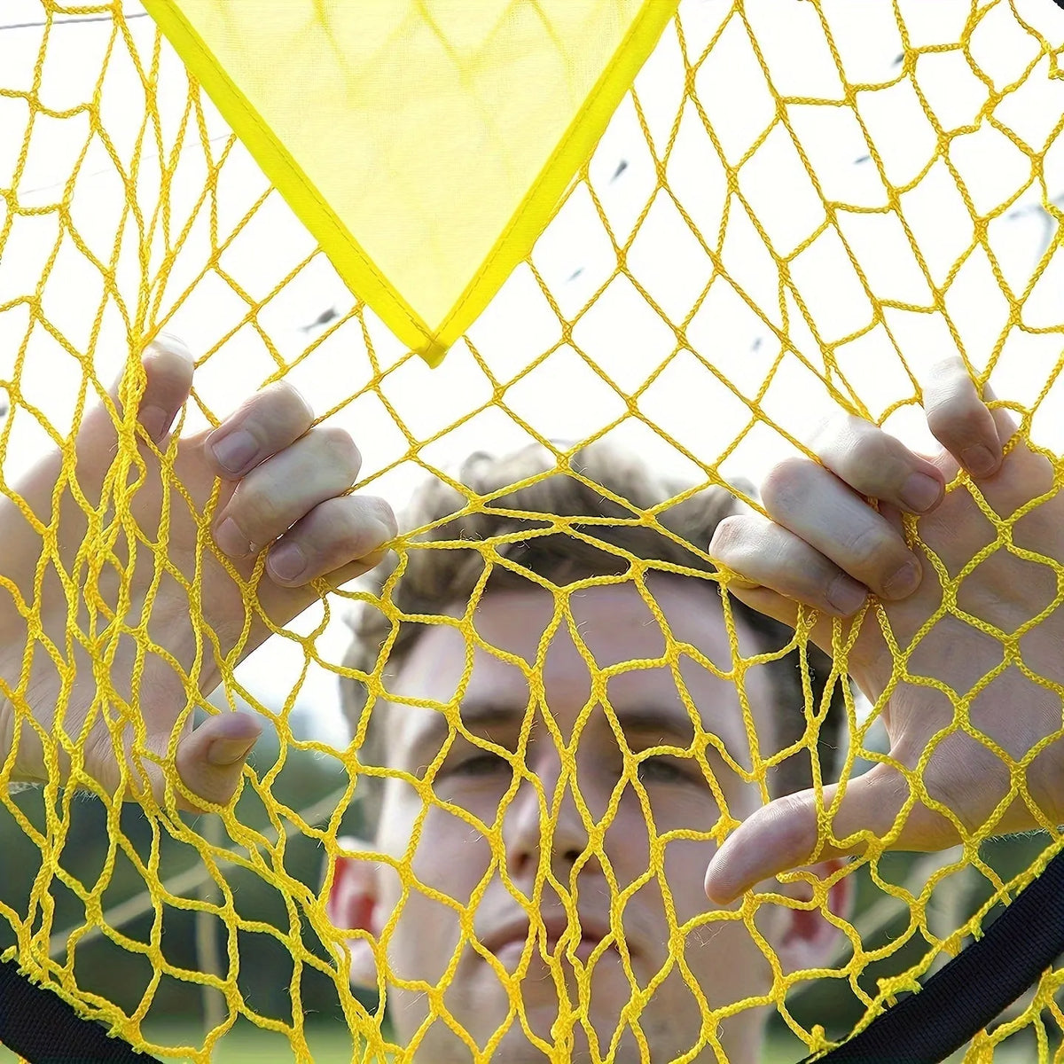 Portable black and yellow football training goal net with four target zones for shooting practice.