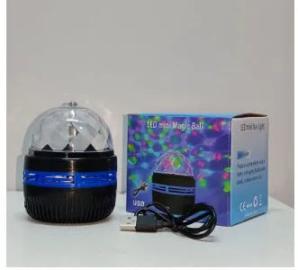 LED star galaxy projector lamp with colourful rotating light on a dark surface