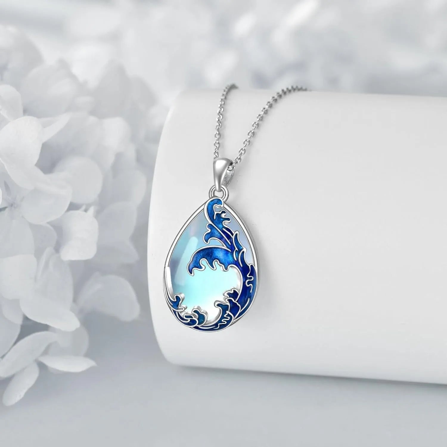 Close-up of a moonstone blue heart-shaped alloy pendant on a women's necklace chain.