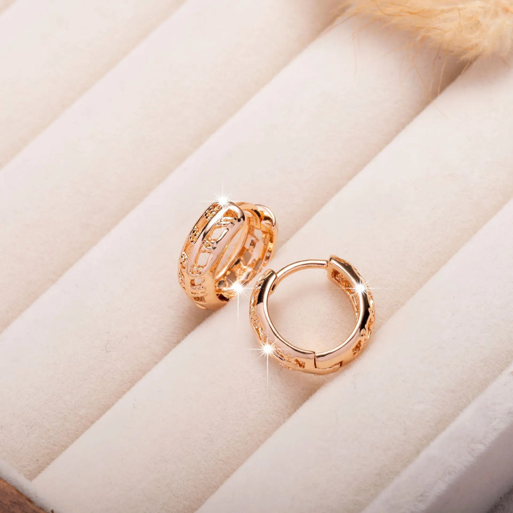Rose gold plated copper earrings with hollow heart and leaf shapes, shown from front, approx 2.5cm tall.