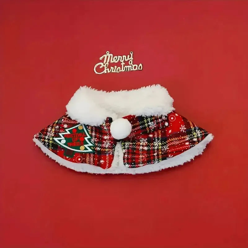 Red festive pet cloak with bell design draped on a small dog, showing integrated scarf.