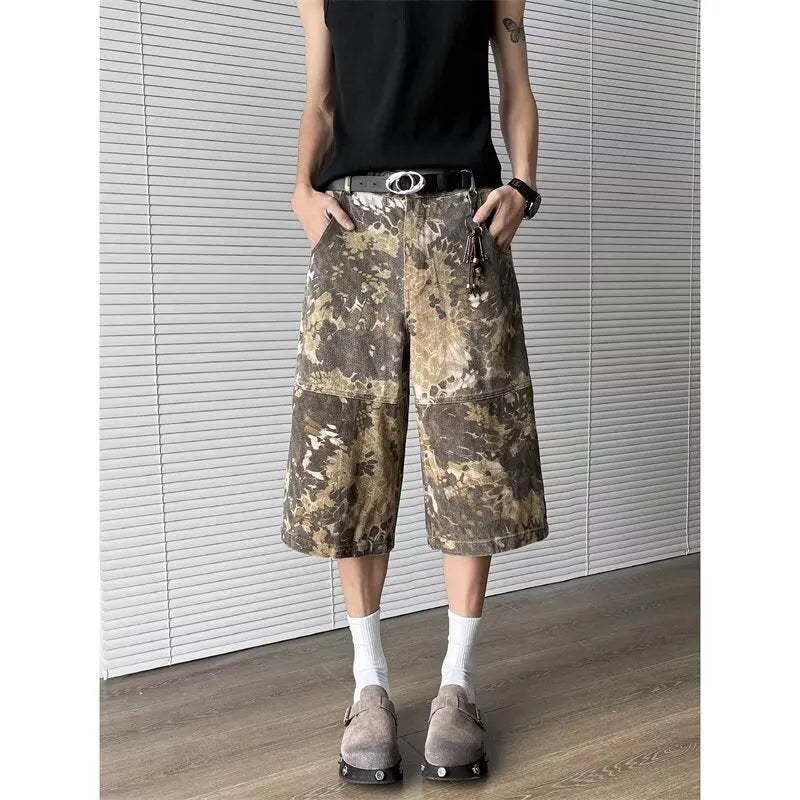 Yellow cotton denim jeans with snake camouflage pattern and cropped leg length.