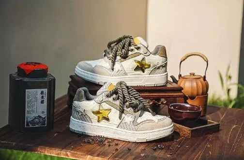 Green low-top casual sneakers with white star pattern stitching, round toe, and flat rubber sole on a white background.