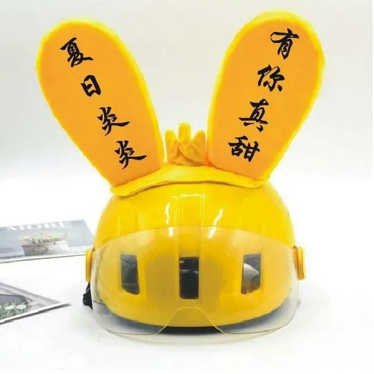 Rabbit ears helmet ornament with Velcro base for skiing and cycling, shown in blue and yellow light-up styles.