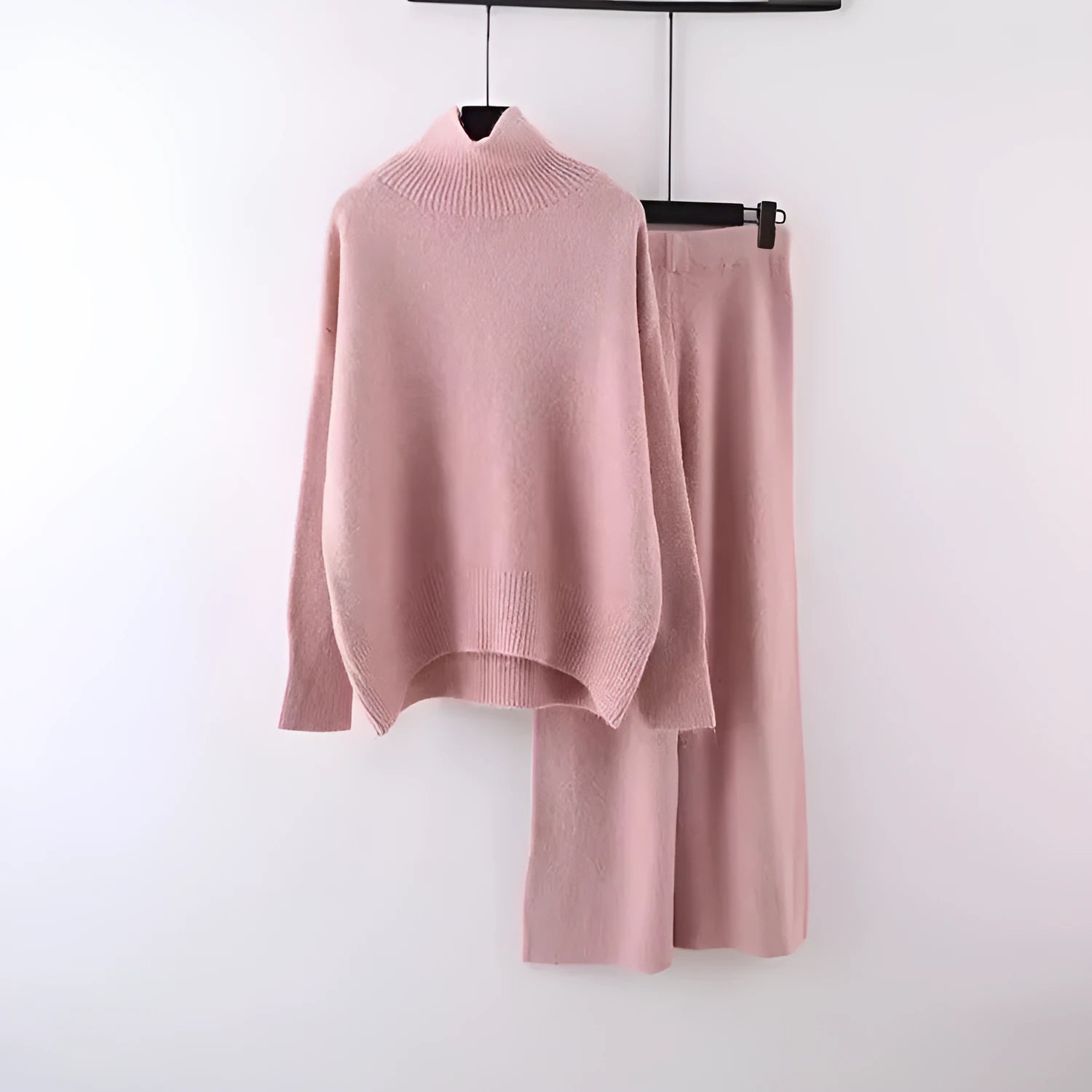Women's beige acrylic knit sweater and wide-leg trousers two-piece set laid flat.