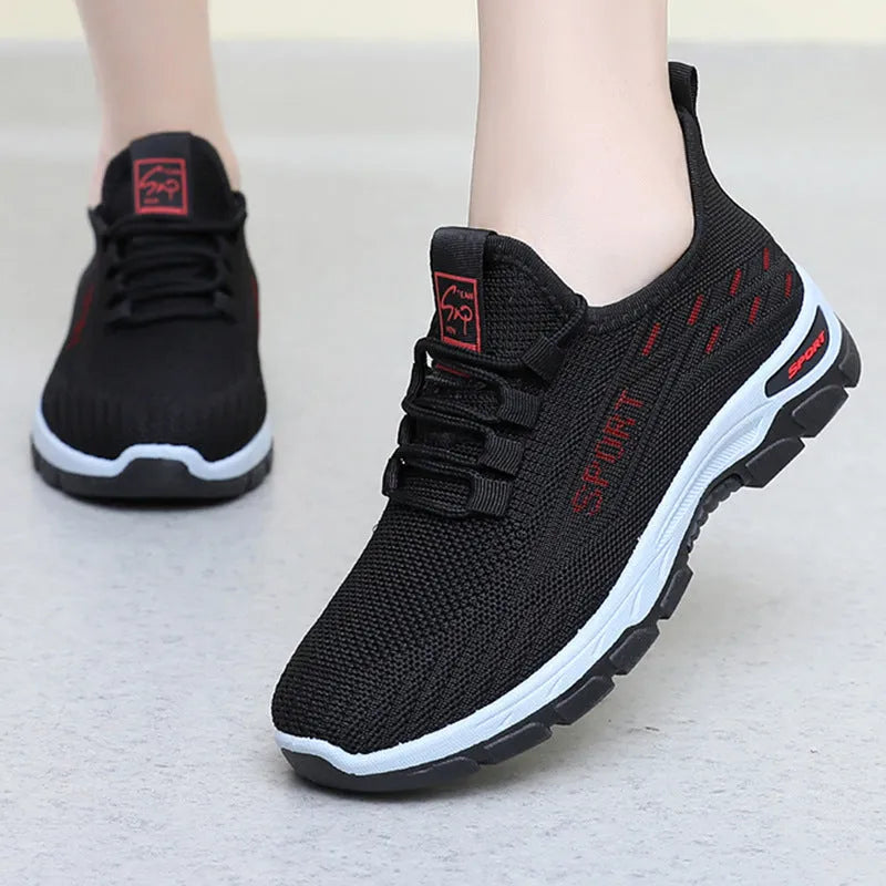 Low-top casual sneaker with round toe and PVC sole in black, shown on a white background.