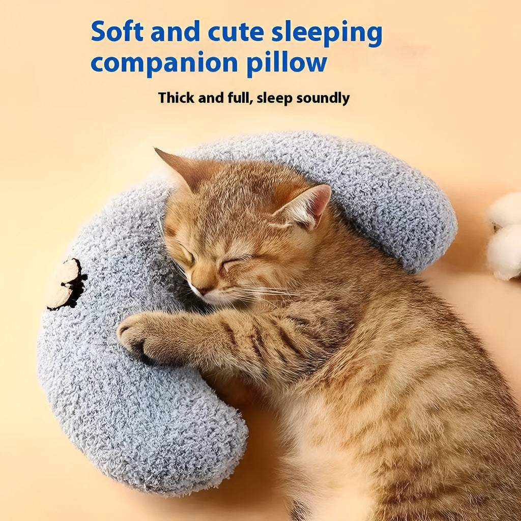 Blue Question Mark shaped cat sleeping mat with integrated U-shaped neck support pillow on a cage floor.