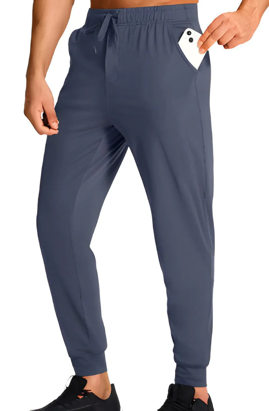 Man wearing loose-fitting solid colour casual trousers in a leisure setting.